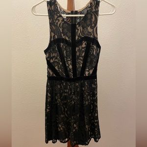 Black lace over nude sleeveless dress